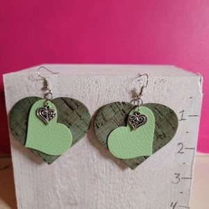 Hand-made Faux-leather green hearts earrings with silver tone charm.